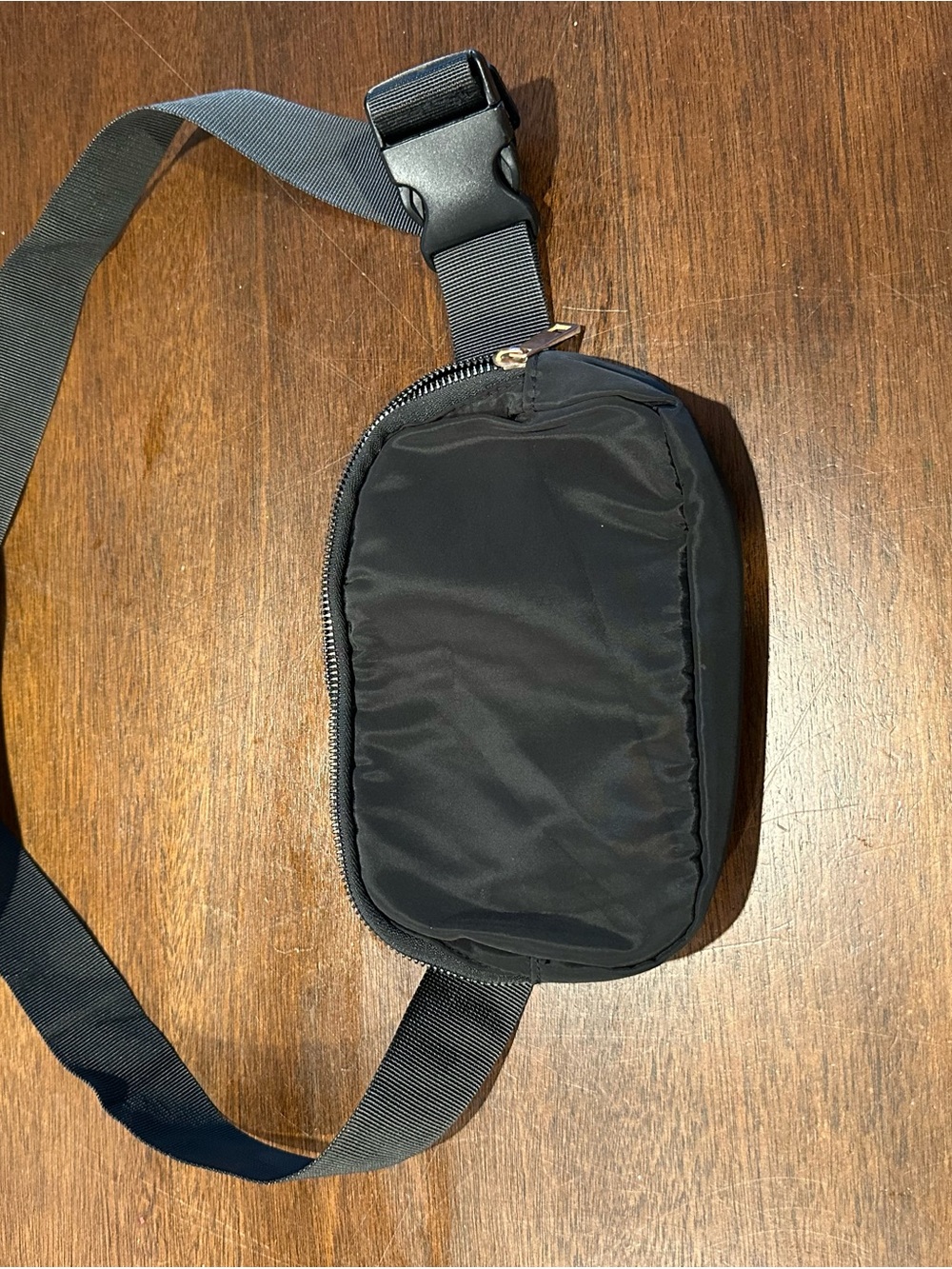 Black nylon waist pack with adjustable strap 
A7:1365